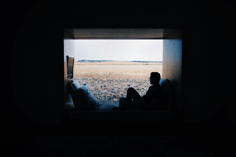 person sitting while looking outside