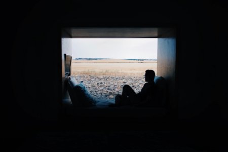 person sitting while looking outside
