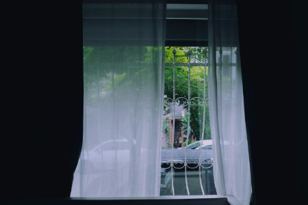 white curtain on white metal window photo