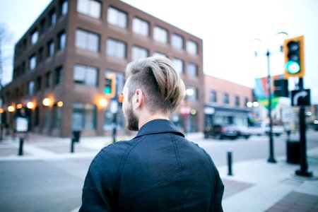 man standing on street photo