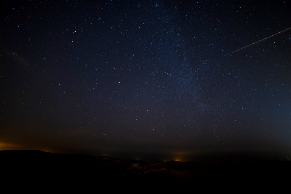 landscape photograph of meteor falling in the sky