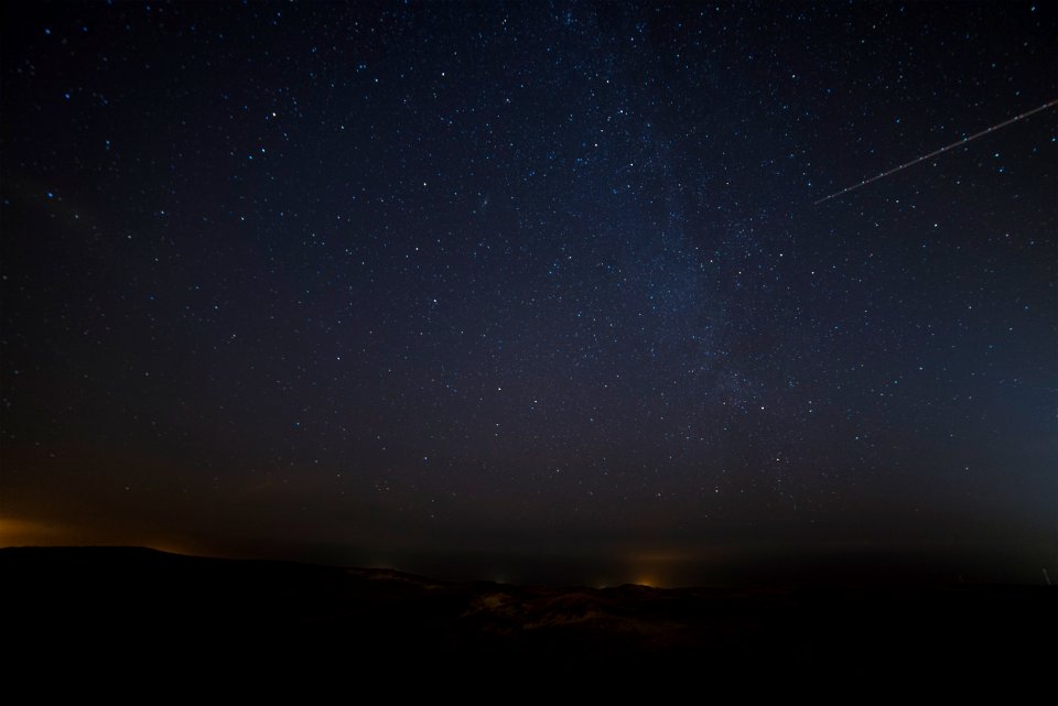 landscape photograph of meteor falling in the sky photo