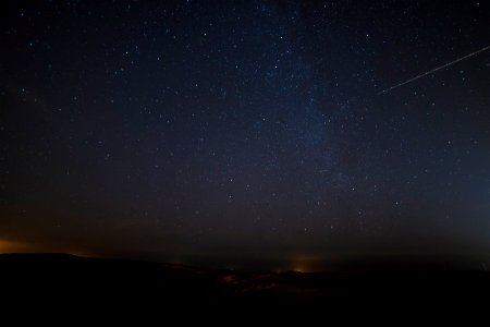 landscape photograph of meteor falling in the sky photo