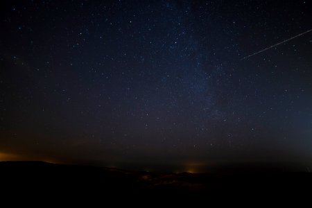 landscape photograph of meteor falling in the sky