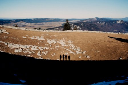 shadow of 4 people on dirt ground