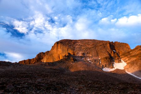 brown rock cliff under mid cloudy sky photo