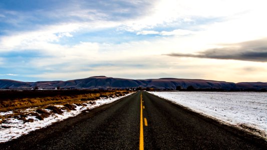 snow beside road under blue sky during day time photo