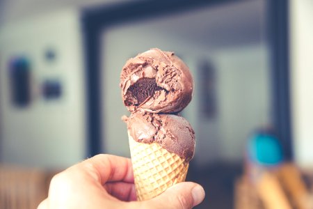 selective focus photography of chocolate ice cream on brown cone photo