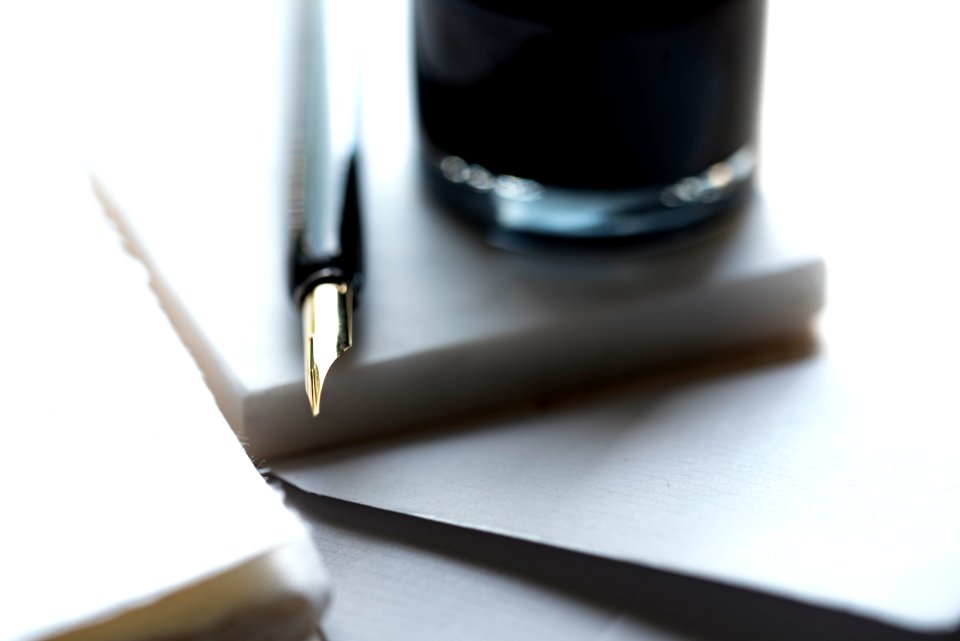 fountain pen beside the glass