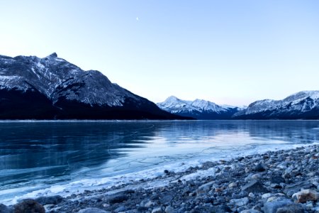 body of water surrounded with snowy mountain