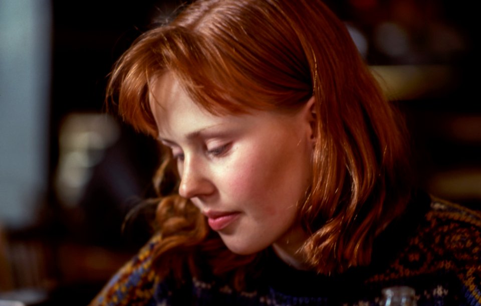 woman wearing knit top near chair