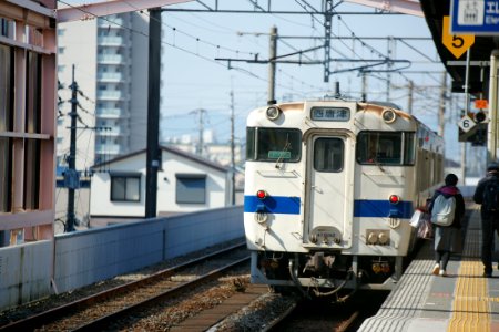 white train passing on subway photo