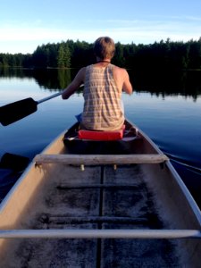 man sitting on boat at daytime photo