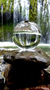 clear glass ball on brown rock