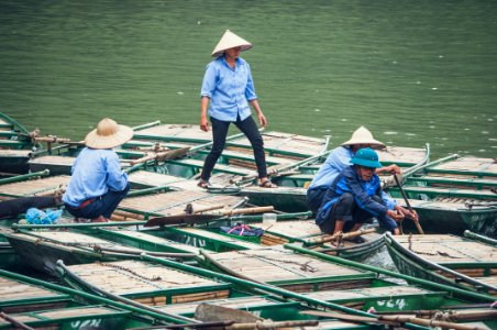 four men standing on boat during daytime photo