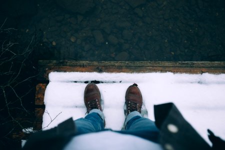 person standing on the edge of brown wooden surface photo