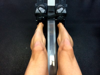 person sitting on rowing machine photo