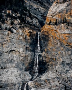 waterfalls between rugged mountain at daytime photo