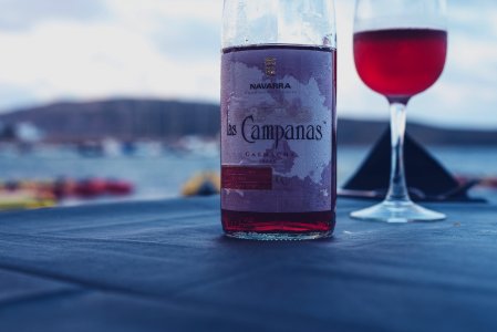 Campanas red wine bottle beside wine glass photo