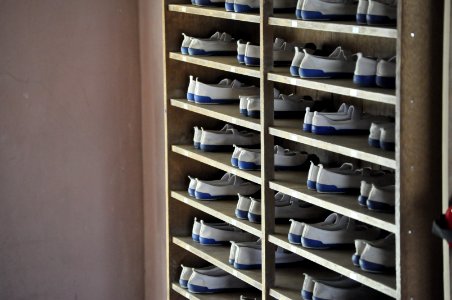 white and blue shoes in rack inside room photo