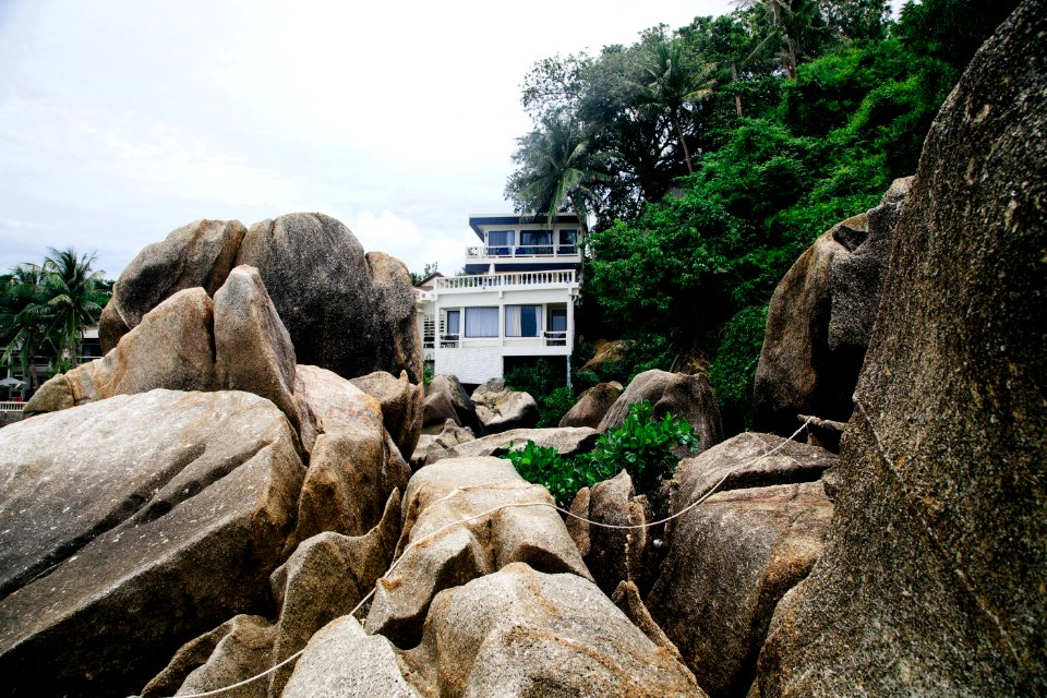 architectural photography of house in the middle of rock formation