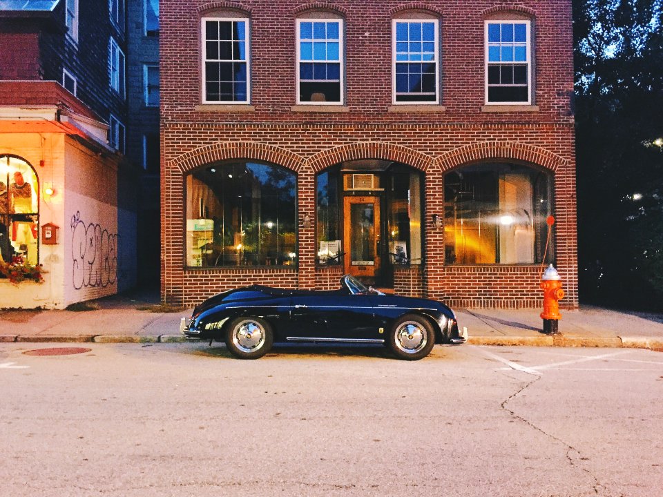 convertible parked outside store
