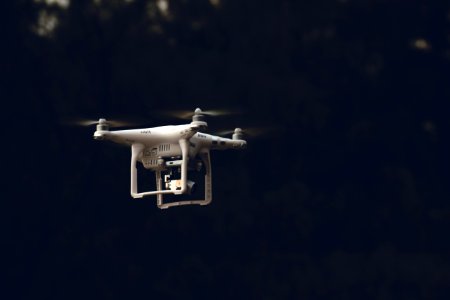 white DJI phantom-series quadcopter flying during daytime photo