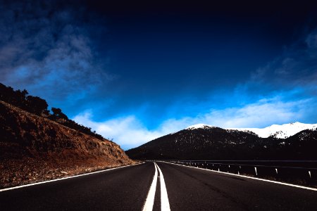 road near mountain under blue sky photo