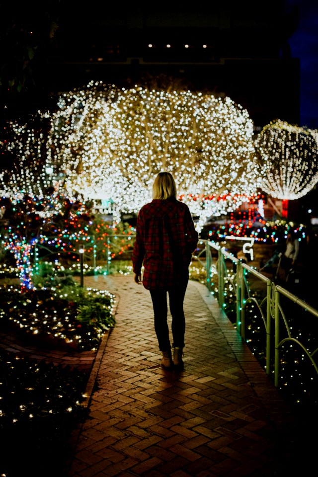 woman wearing brown jacket at night