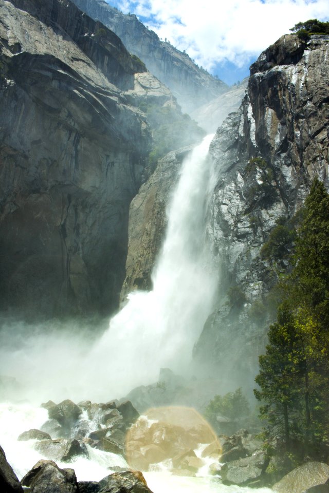 waterfalls in the middle of green trees