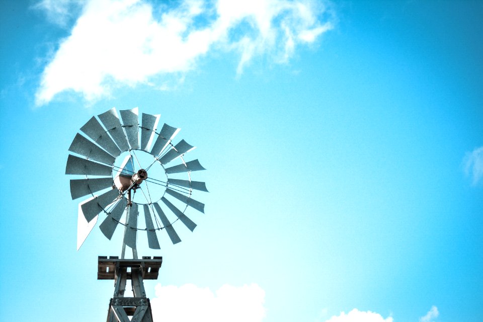 windmill under blue and white cloudy skies at daytime