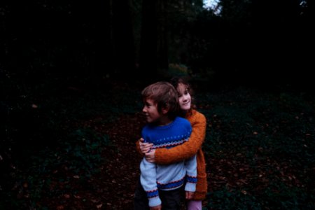 girl and a boy in a forest photo