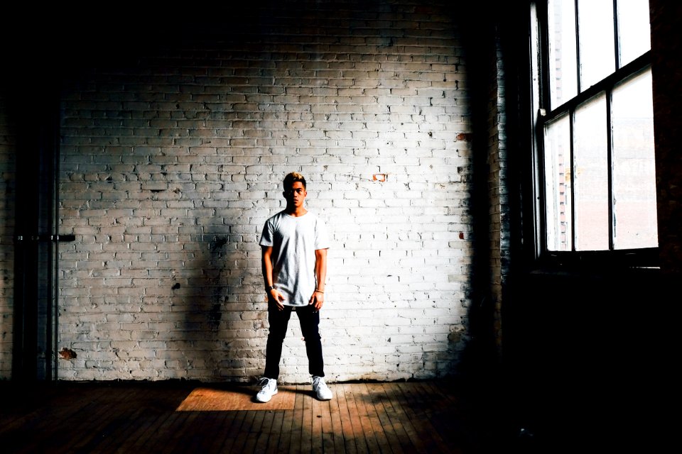 man standing in front of white wall