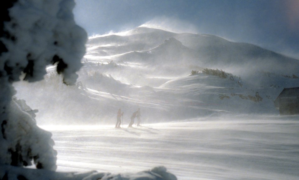 three man walking in snow covered mountain