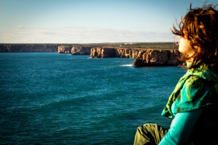 woman sitting at the seashore photo