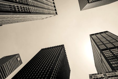 low angle and grayscale photography of high-rise buildings photo