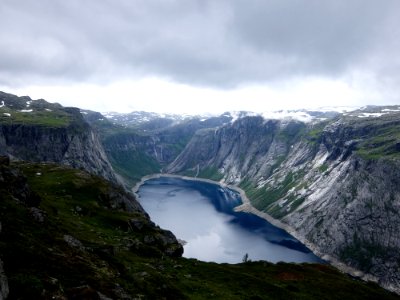lake surround by mountains under white sky