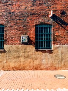 black metal window on brown brick wall