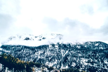 snow covered mountain under white clouds during daytime photo