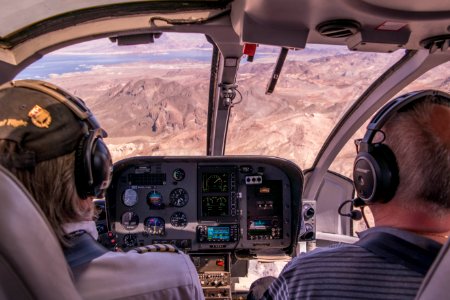 two person riding plane near mountains during daytime photo