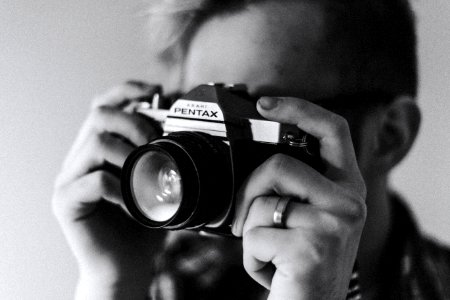 grayscale photo of man taking photo photo