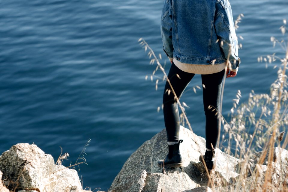 woman standing on cliff photo