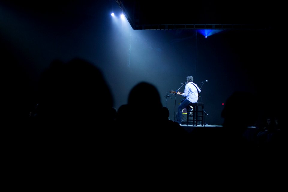 man playing guitar on stage