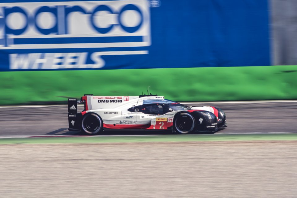 white and black sports car racing on track