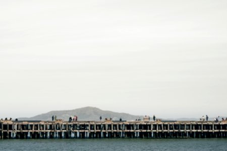 photography of concrete bridge near the body of water photo