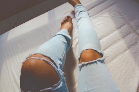 women's distressed blue denim jeans photo