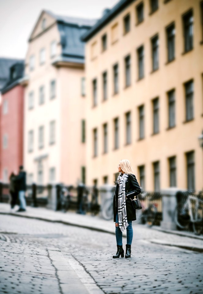 woman standing on pathway near building during daytime