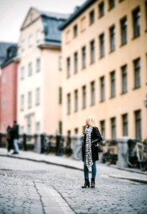 woman standing on pathway near building during daytime photo