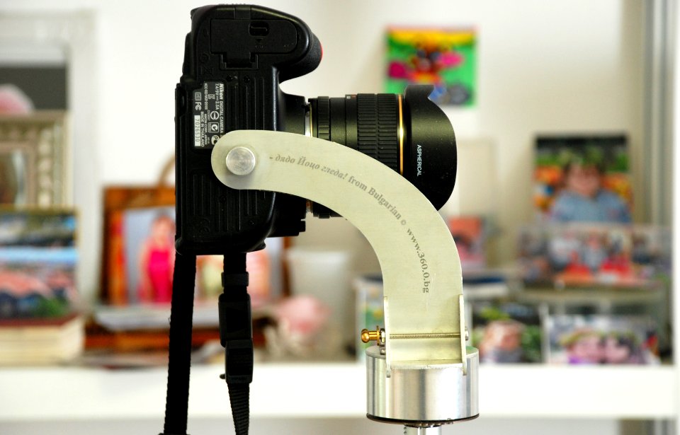 black DSLR camera on grey metal camera holder