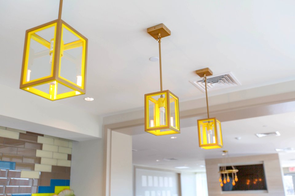 three yellow pendant lamps